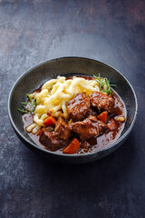 Traditionelles ungarisches geschmortes Hirschgulasch mit Gemüse und Spätzle in würziger Sauce...