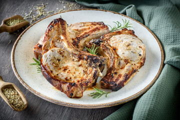 Juicy and served pork chops on the plate