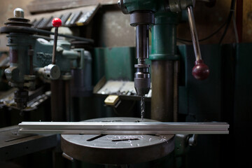 Drilling on the aluminum frame with a drilling machine
