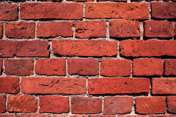 Old red brick texture wall, white seams, close up. Brick background.