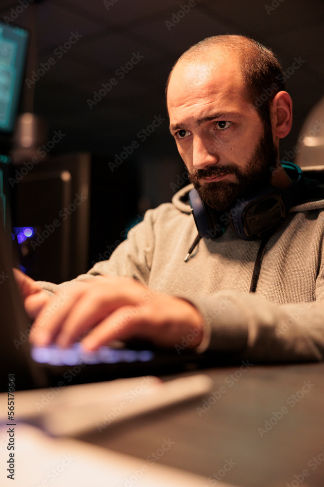Poster male hacker using computer to break into corporate data servers and infect software system with dang