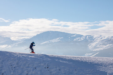Naklejka na ściany i meble man and woman skiing and snowboarding in the mountains, ski resort