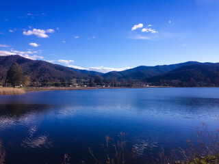 Enjoying peaceful view of lake in the mountain during family children school holiday with outdoor travel destination under clear blue sky