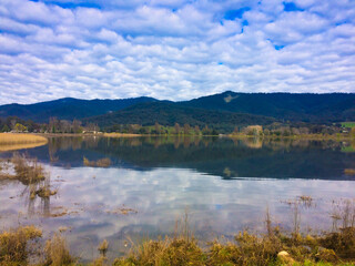 Enjoying peaceful view of lake in the mountain during family children school holiday with outdoor travel destination under clear blue sky
