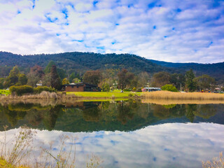 Enjoying peaceful view of lake in the mountain during family children school holiday with outdoor travel destination under clear blue sky