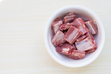 Raw pork ribs in white bowl