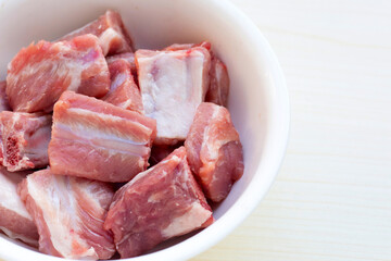 Raw pork ribs in white bowl