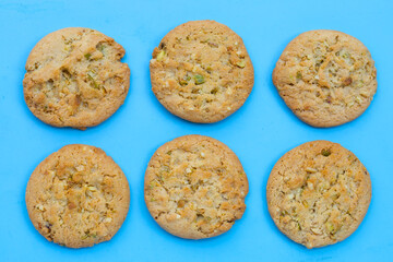 Pistachio and almond cookies on blue background.