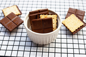 Square biscuits in dark chocolate