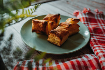 Top and side view of puffed pastry and cheese or Greek yogurt on wooden background 