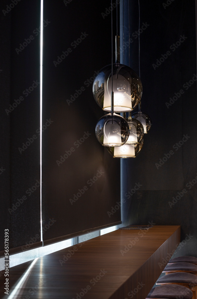 Aufkleber roller blinds in the cafe. solar shades black color in the urban style interior. wooden table near t
