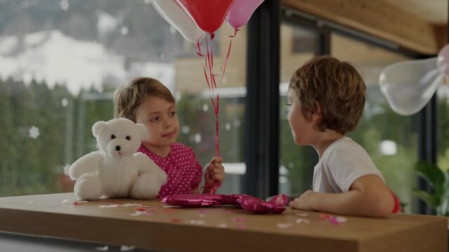Boy and girl at the bar table in the decorated room for Valentine's Day