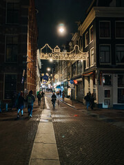 street view with lights at night in amsterdam damstraatjes