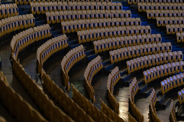 Empty seats in a large empty rounded hall