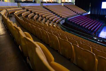 Fototapeta premium Yellow and red seats surround the stage