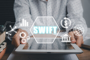 SWIFT, Society for Worldwide Interbank Financial Telecommunications, Business person using tablet...