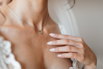 beauty, people and jewelry concept - beautiful young woman wearing shiny diamond pendant