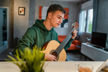 One man teenager learn to play guitar at home online lesson tutorial