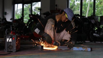 Closeup of a Worker Cutting Iron With an Iron Cutting Machine. A Shining and Enchanting Spark.