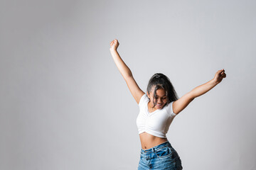 Girl celebrating with arms up. Young winner happy for her achievements. State of happiness for...