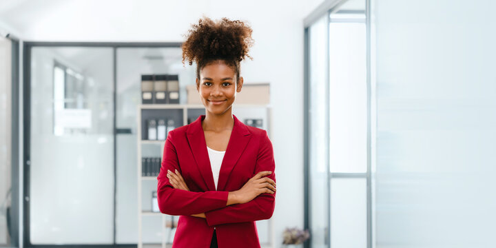 Real estate broker agent working and consult online to decision making sign a contract, Attractive young business woman african american lawyer standing hands crossed looking camera.