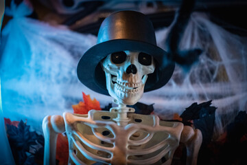 Halloween decoration of a skeleton with a black top hat.
