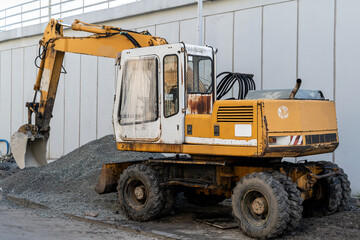 Orange excavator on the street.