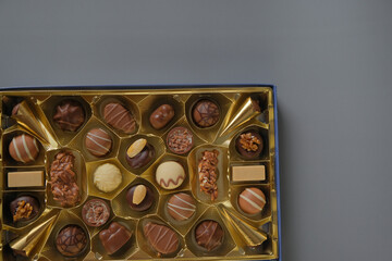 Sweets and desserts. Assorted chocolate box on a gray background. Chocolate box. Milk chocolate candy.Sweets box in assortment