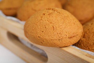 Closeup view of delicious oatmeal cookies on wooden tray