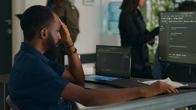 Software developer brainstorming ideas to write code and create new interface in data room. System engineer programming server database in busy artificial intelligence developing agency.