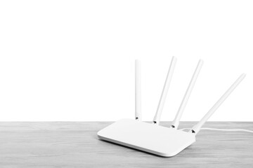 New modern Wi-Fi router on light wooden table against white background. Space for text