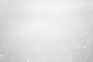 White glitter vintage lights background.  White bokeh shiny on dark background.