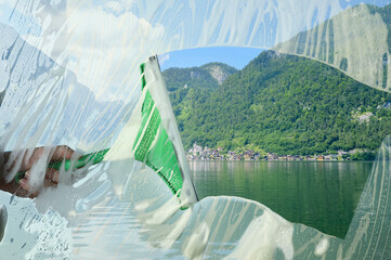 Woman cleaning window with squeegee, closeup. Picturesque lake and mountains on sunny day, view...