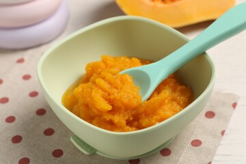 Baby food. Tasty pumpkin puree on white wooden table, closeup