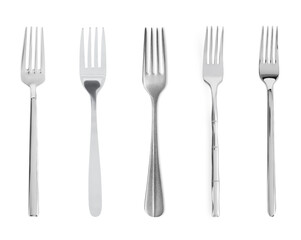 Set of shiny metal forks on white background