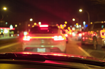 Night road in a city of lights cars traffic jam. Blurred Defocused Lights of Heavy Traffic. The city lights. Motion blur