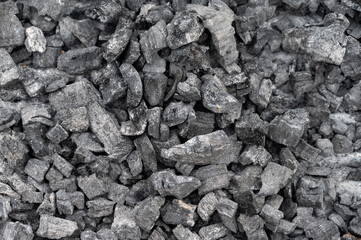 Full frame shot of the black coals. Coal is a fossil fuel, formed from vegetation