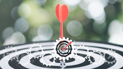 dart arrow hitting in the target center of dartboard,Business targeting and focus concept,the...