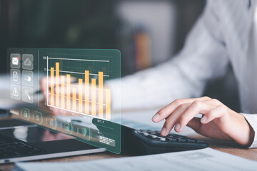 Businessman calculating figures in company financial documents with a calculator,analysis of company financial data,Planning to assess and review budgets,concept of finance and investment