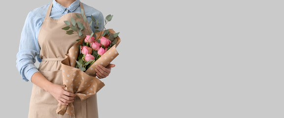 Female florist with bouquet on light background with space for text - Powered by Adobe