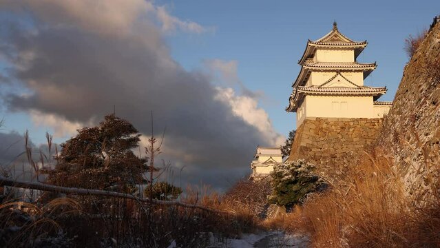 Stationary view of historic Japanese castle on snowy winter morning