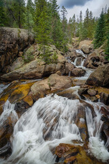 The Fall River flows through the giant granite boulders that make up Chasm Falls in Rocky Mountain...