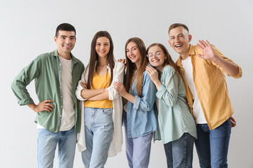 Obraz premium Group of happy friends on light background