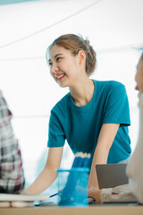 Beautiful smiling asian woman working on computer in workplace with business team Group of Asian company employees and colleagues working together in the office by talking and giving advice