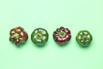 Row of bell peppers on color background