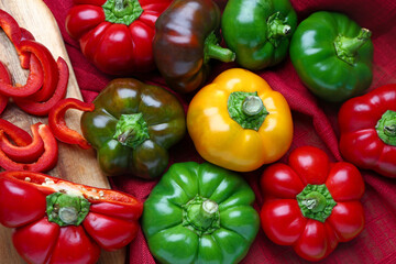Different bell peppers on fabric background