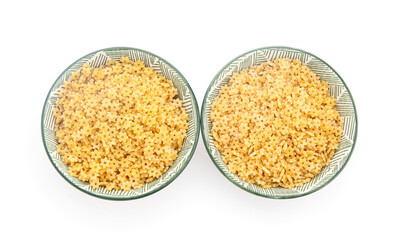 Bowls of raw stelline pasta on white background