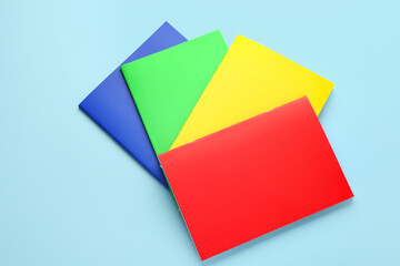 Bright notebooks on color background