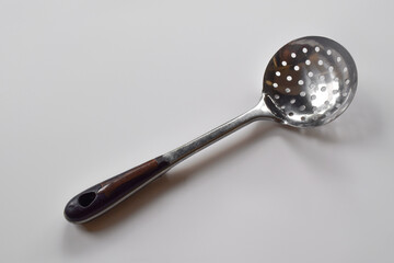 Stainless Steel Round Kitchen Skimmer or Skimmer Spoon Isolated on White Background.