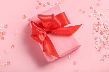 Beautiful gift for Valentine's Day celebration and sequins on pink background